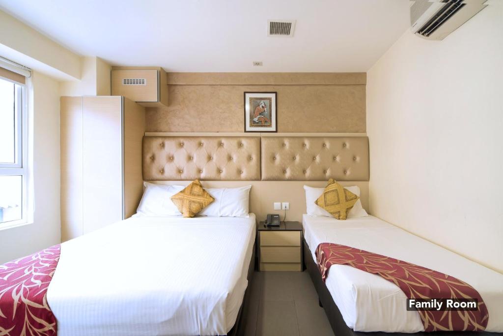 Postel nebo postele na pokoji v ubytování Sandpiper Hotel Singapore