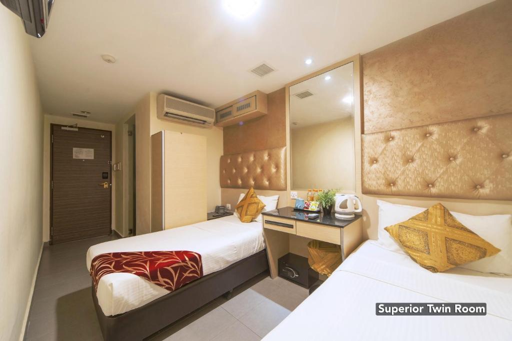Postel nebo postele na pokoji v ubytování Sandpiper Hotel Singapore