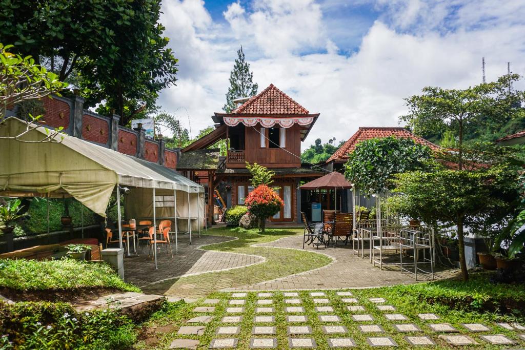 a courtyard of a house with a table and chairs at Bantal Guling Villa in Lembang