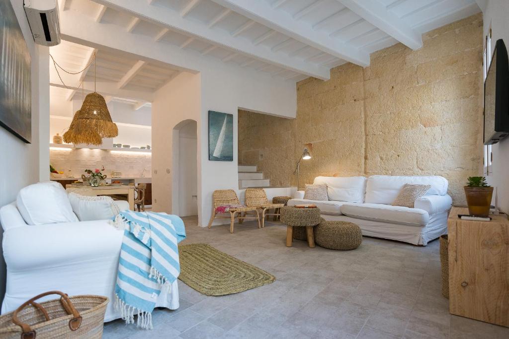 a living room with white couches and a table at roques in Ciutadella