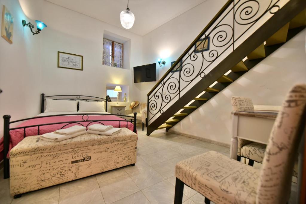 a bedroom with a bed and a staircase at 2-level Apartment "Mandraki" in Hydra