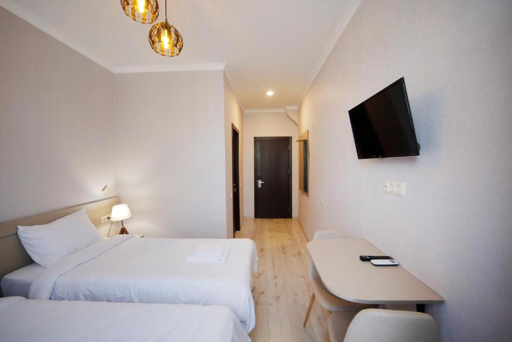 Postel nebo postele na pokoji v ubytování Hotel Sani Kutaisi