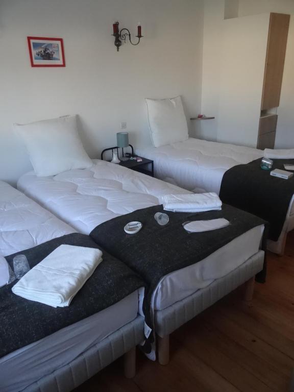 two beds in a room with towels on them at circuit expo zenith in Le Mans
