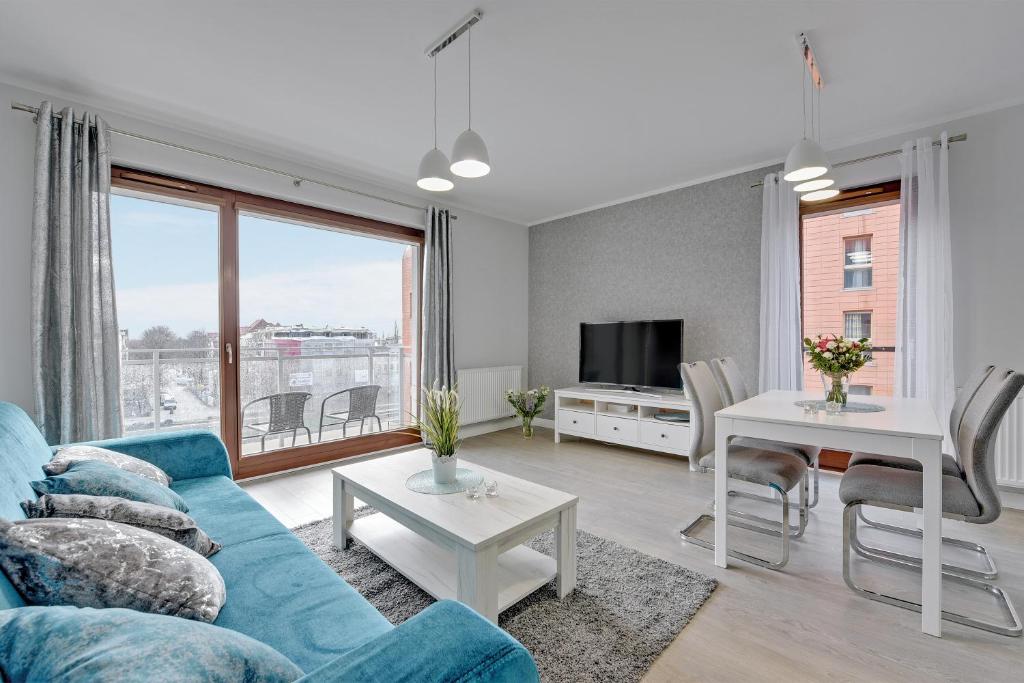 Televízia a/alebo spoločenská miestnosť v ubytovaní GRANO FLATS Gdańsk - Chmielna 73