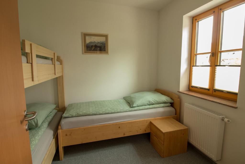 Postel nebo postele na pokoji v ubytování Apartments & Rooms Pr' Skalovc