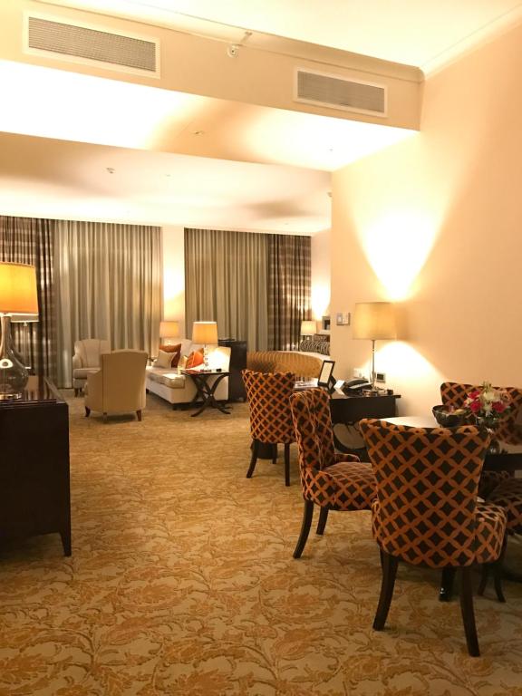 a hotel lobby with chairs and a living room at Taj HotelApart, Taj Hotel Cape Town in Cape Town