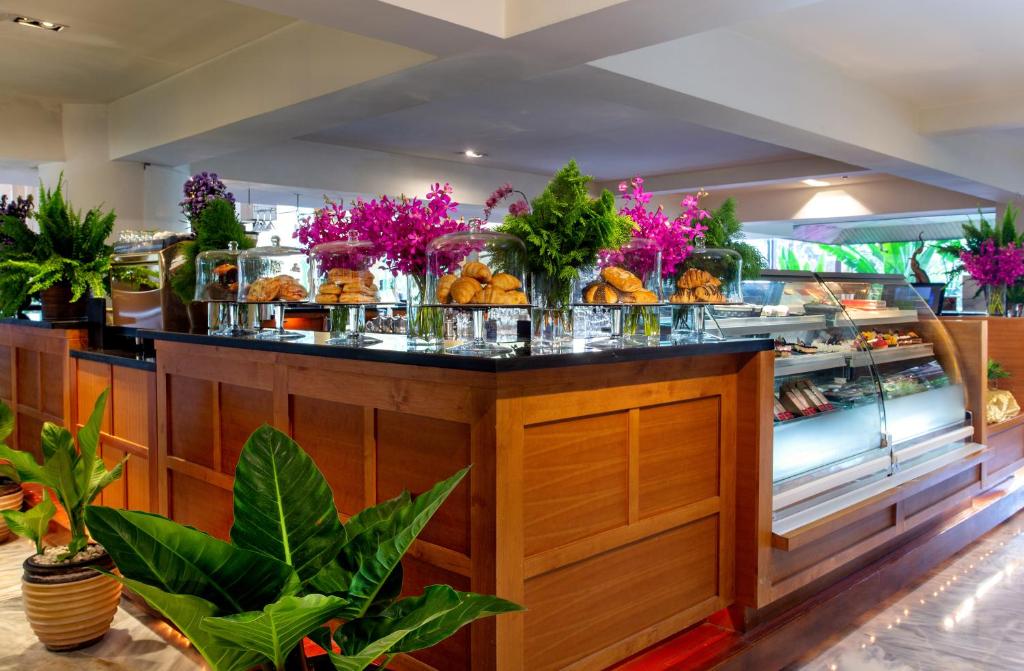 A buffet counter filled with pastries and other prepared foods.