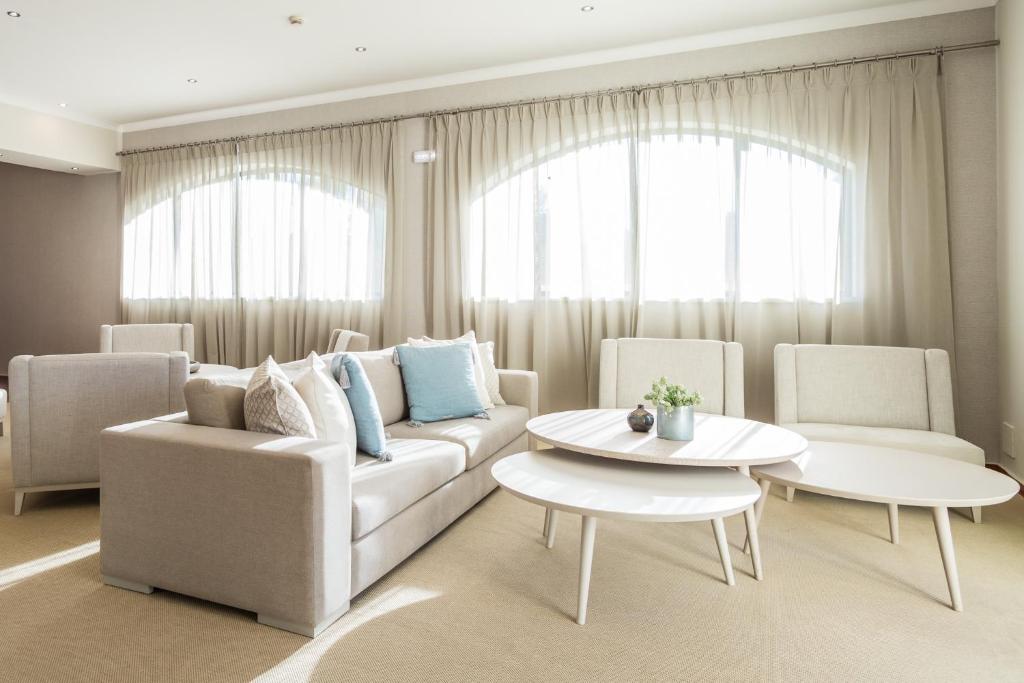 a living room with a couch and two chairs and a table at Mirachoro Carvoeiro in Carvoeiro
