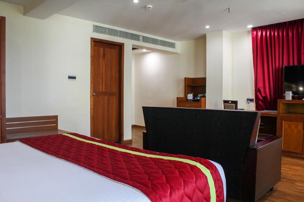 Postel nebo postele na pokoji v ubytování JVK Park Hotel
