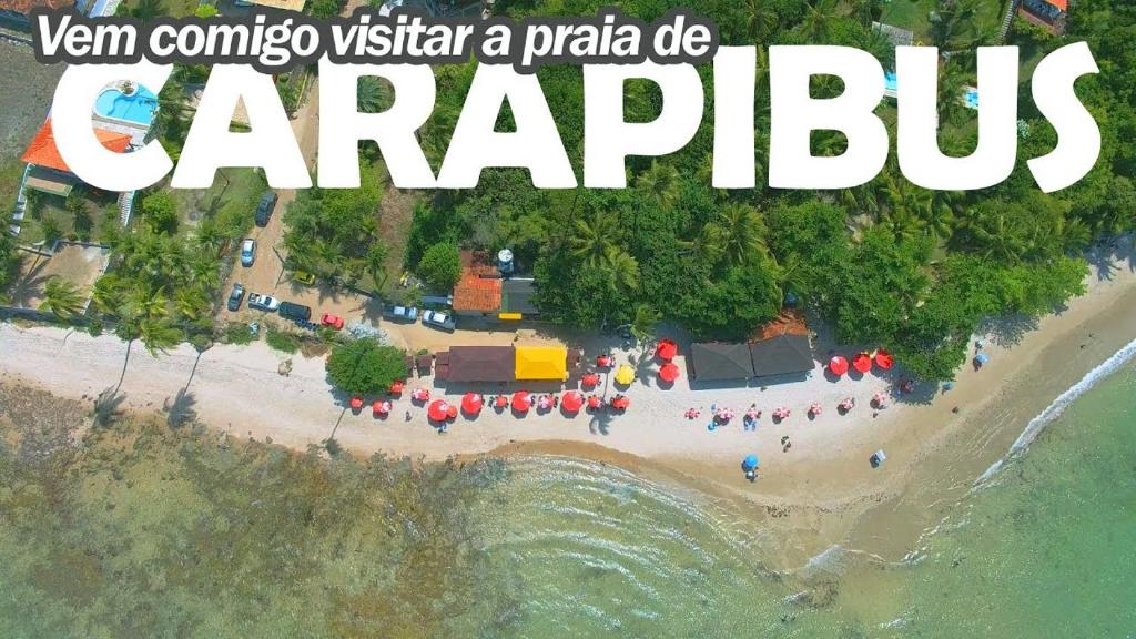 an aerial view of a party on a beach at Suítes Carapibus in Jacumã