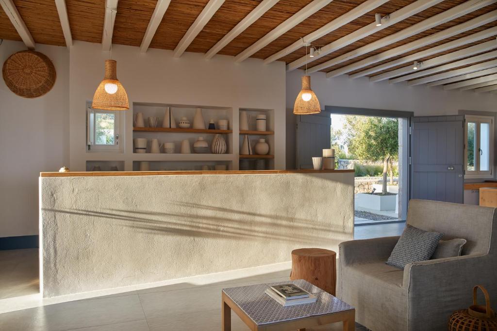 a lobby with a reception desk and a couch at Milos Breeze Boutique Hotel in Pollonia
