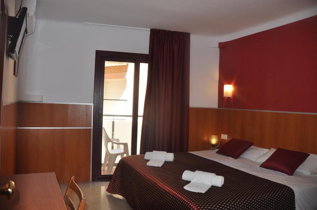 Postel nebo postele na pokoji v ubytování Hostal - Pensión El Amigo