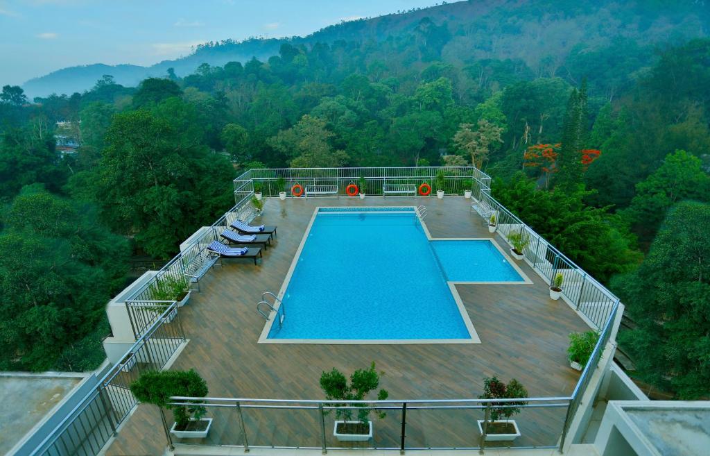 an aerial view of a swimming pool on top of a house at Sterling Thekkady in Thekkady