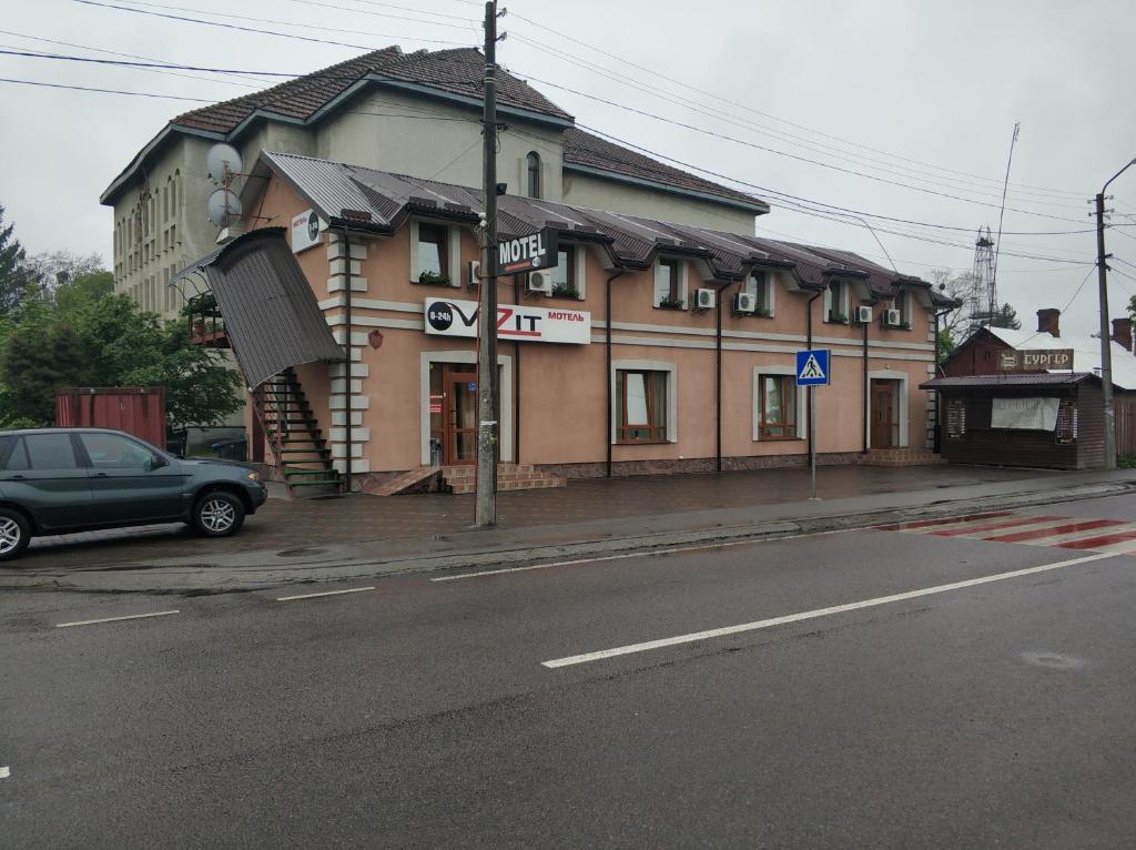 a car parked in front of a building on a street at VIZIT in Stryi