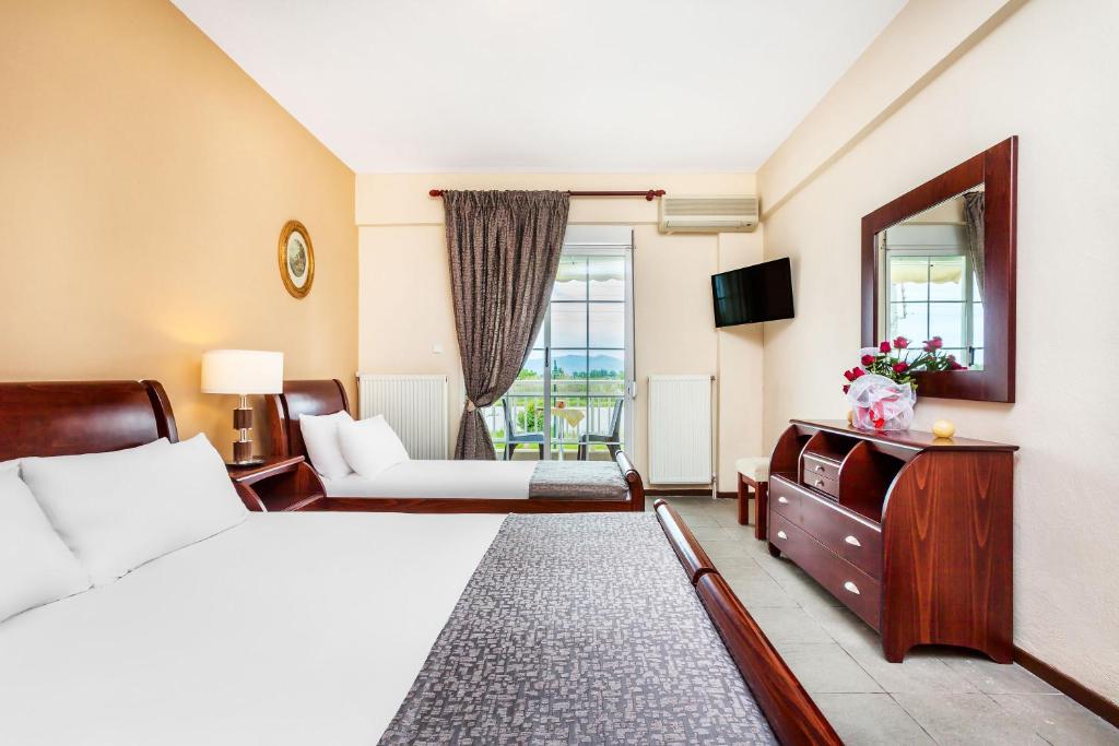 Postel nebo postele na pokoji v ubytování Amfion Hotel