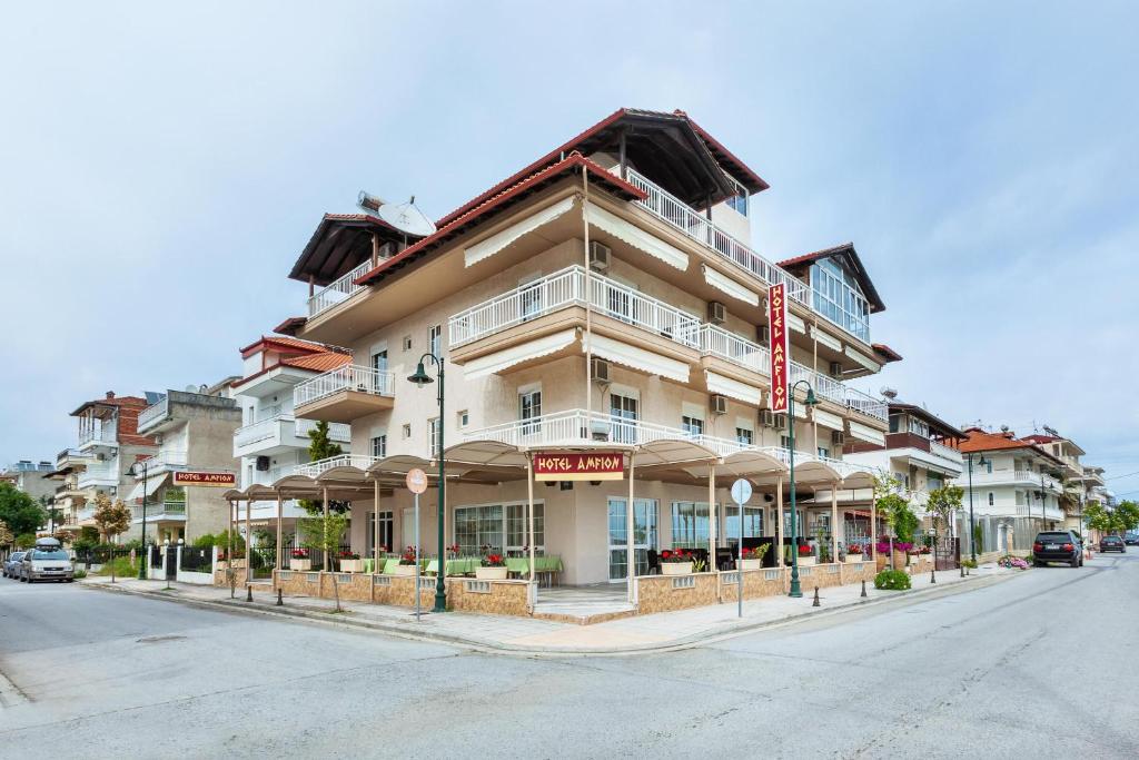 a large building on the corner of a street at Amfion Hotel in Olympic Beach