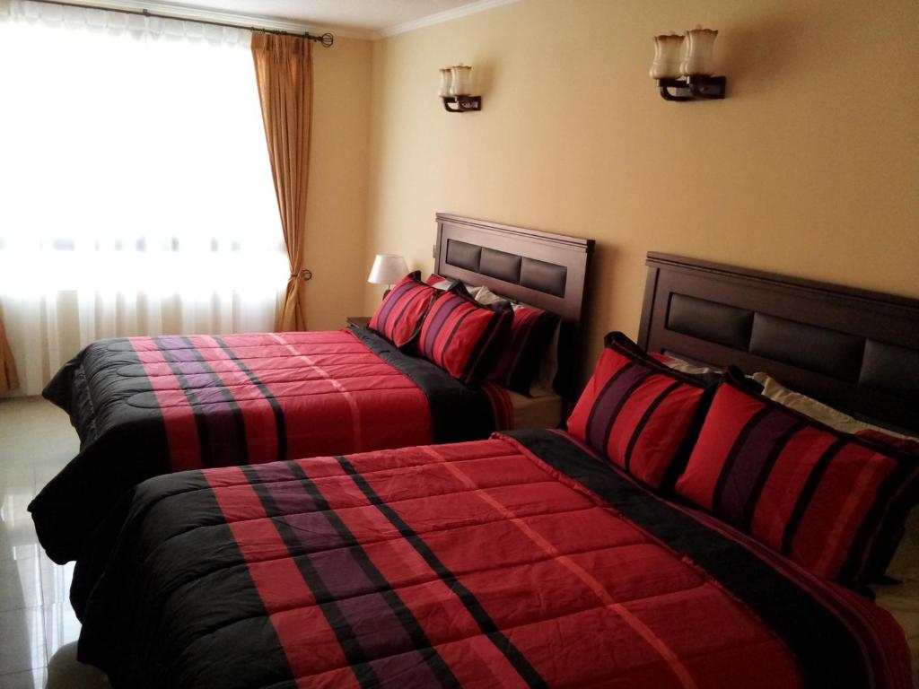 Postel nebo postele na pokoji v ubytování Hotel Astore Suites