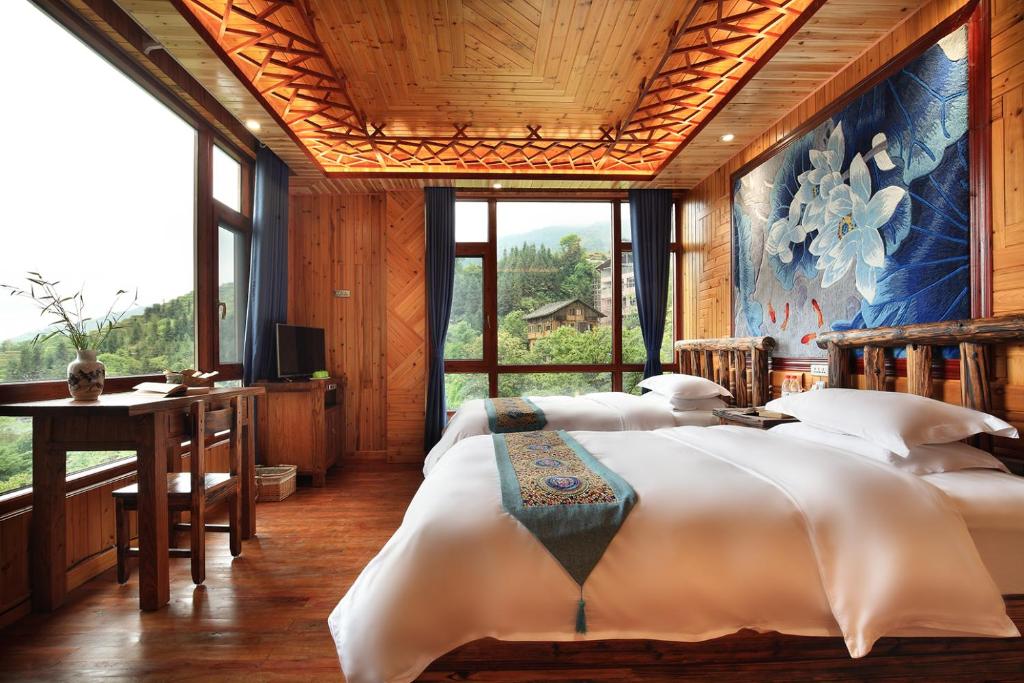 Postel nebo postele na pokoji v ubytování Baike Boutique Hotel