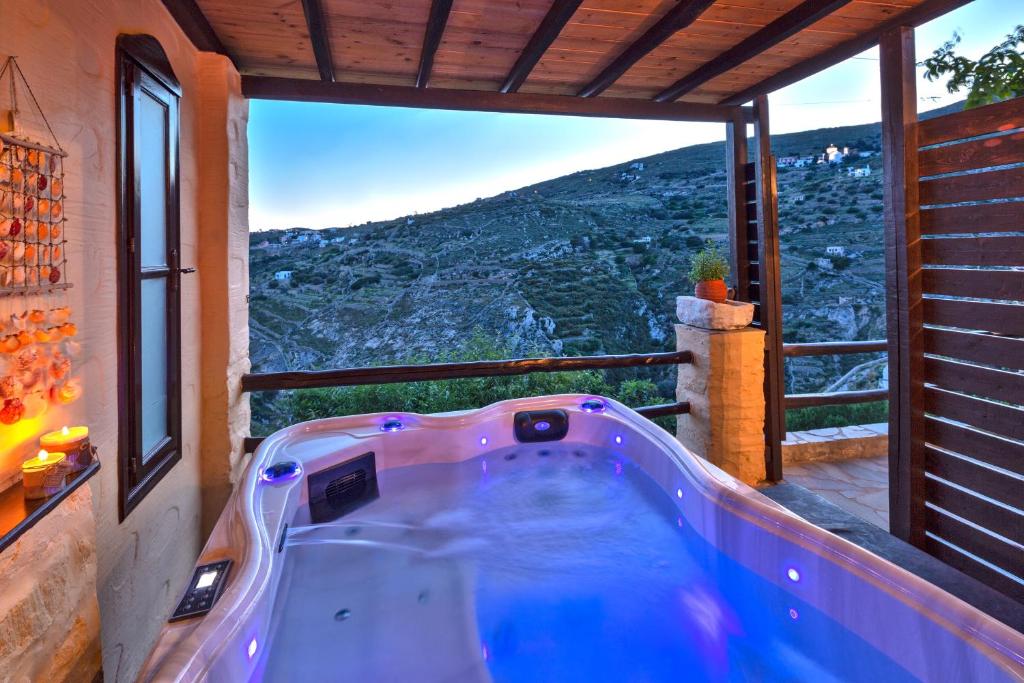 a bath tub in a room with a view at Fimaira in Ermoupoli