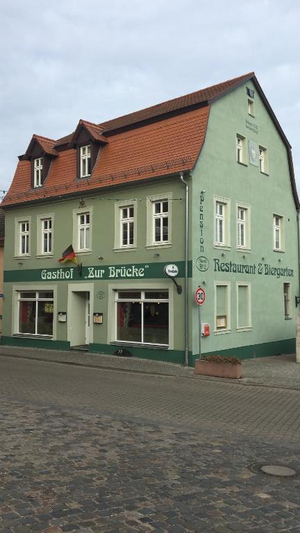 a large building on the side of a street at Gasthof " Zur Brücke" in Alsleben