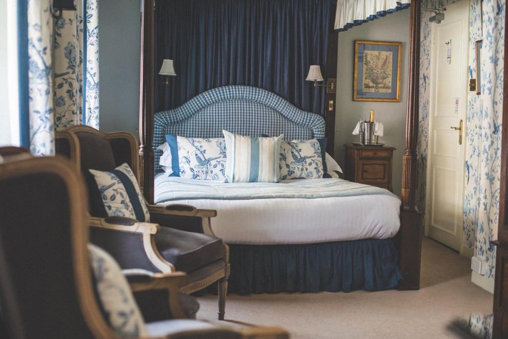 a bedroom with a bed with blue and white pillows at Jeakes House in Rye