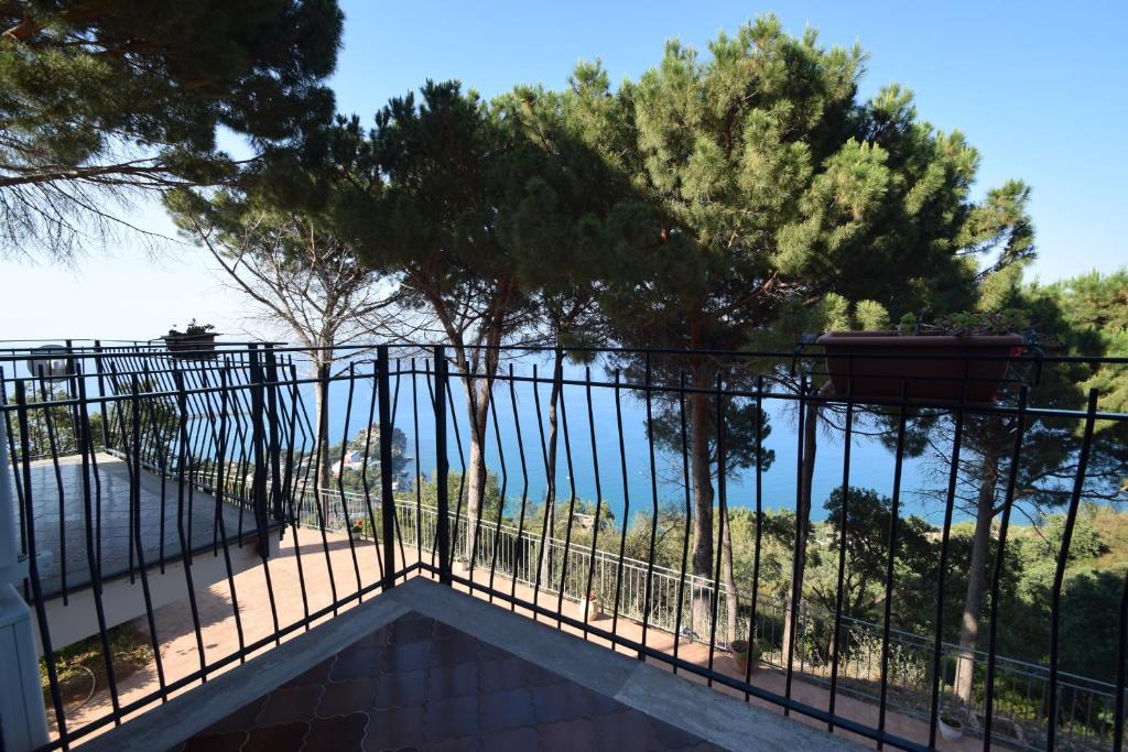 a balcony with a view of the ocean at Alba Tra I Pini B&B in Cefalù