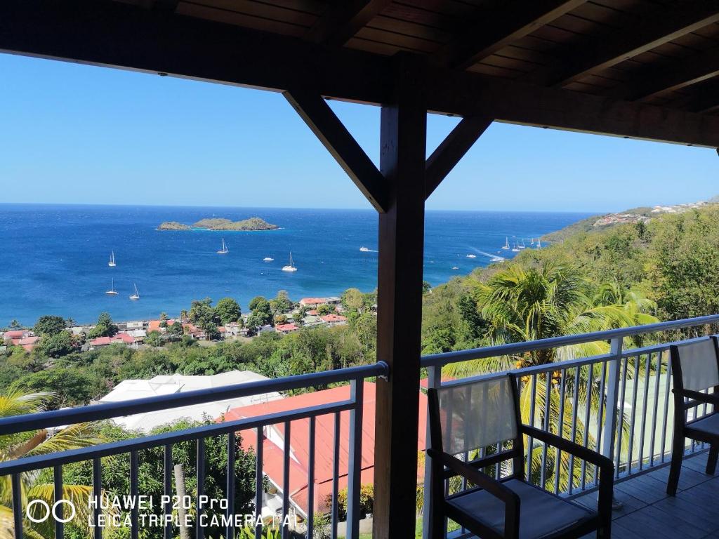 a view of the ocean from the balcony of a house at 13 residence belle de nuit in Bouillante