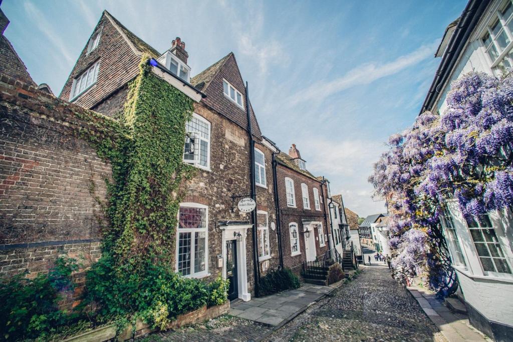 a row of brick houses with purple wreaths on them at Jeakes House in Rye