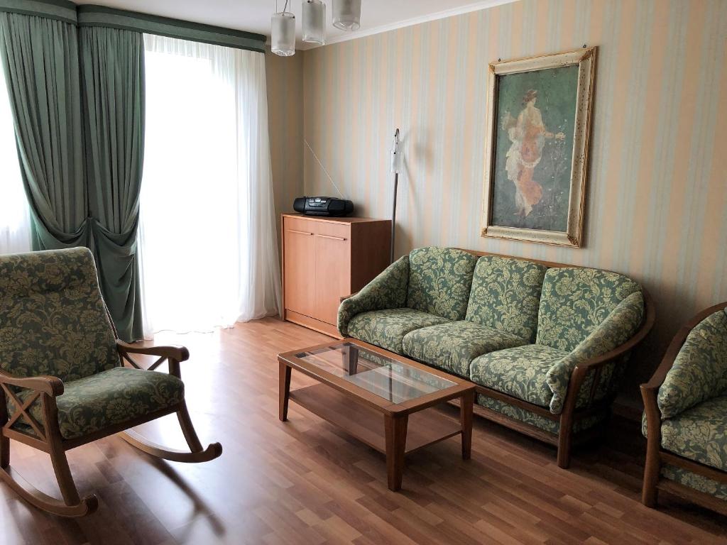 スヴェトロゴルスクにあるApartment in Svetlogorskのリビングルーム(ソファ、椅子2脚、テーブル付)