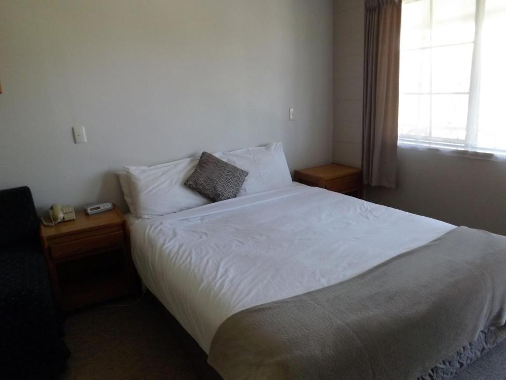Postel nebo postele na pokoji v ubytování Karaka Tree Motel