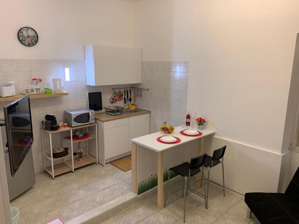 a small kitchen with a table and chairs in it at Duplex Catania Airport in Catania