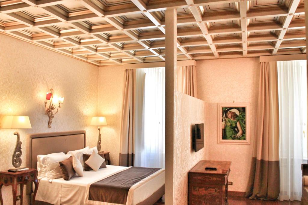 a bedroom with a bed and a coffered ceiling at Di Rienzo Pantheon Palace in Rome