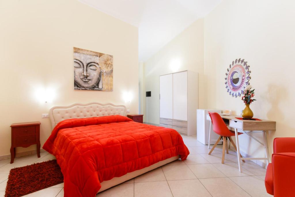 a bedroom with a red bed and a desk at Su Soi in Càbras