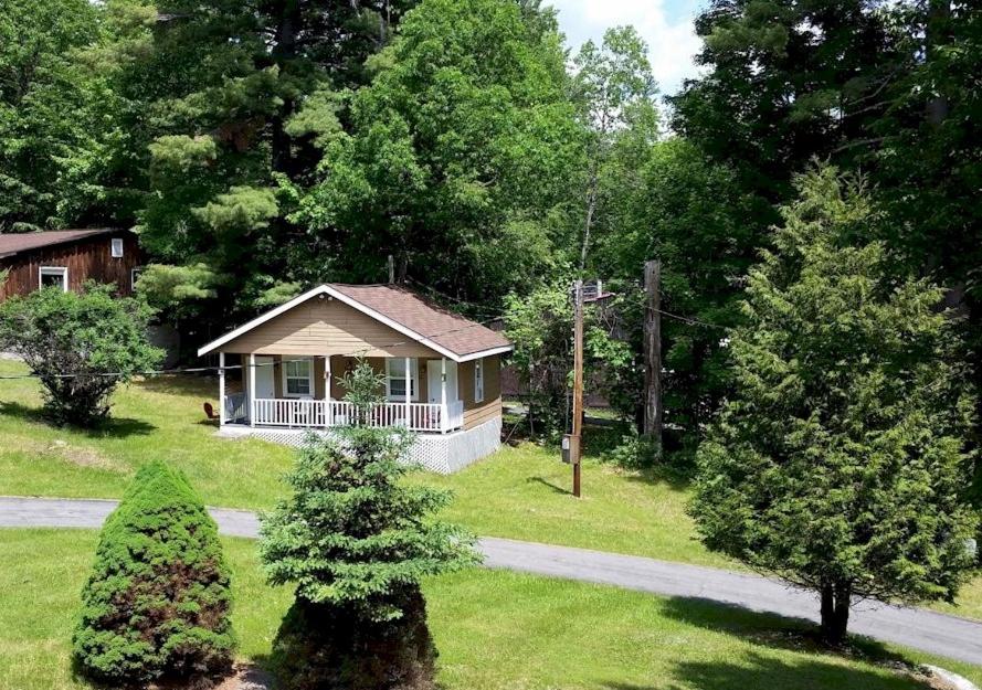 a small house in the middle of a yard at Rock Castle Resort in Lake George