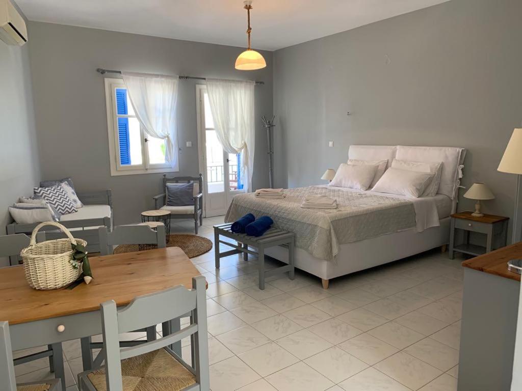 a bedroom with a bed and a living room at Kiki Studios in Fiskardo