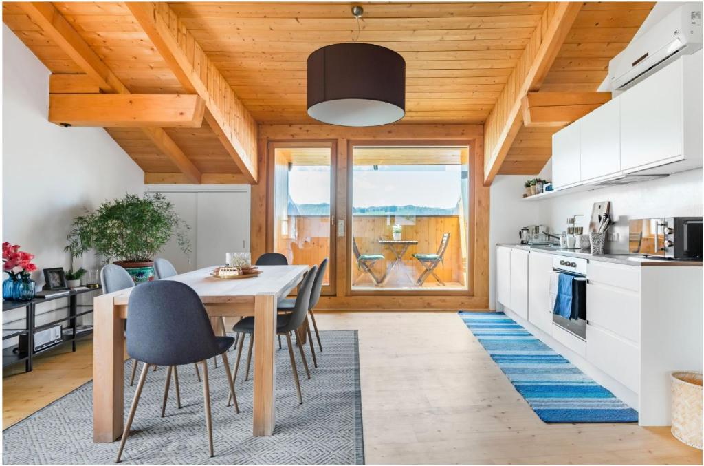 a kitchen and dining room with a table and chairs at Lions Apartments in Völs am Schlern