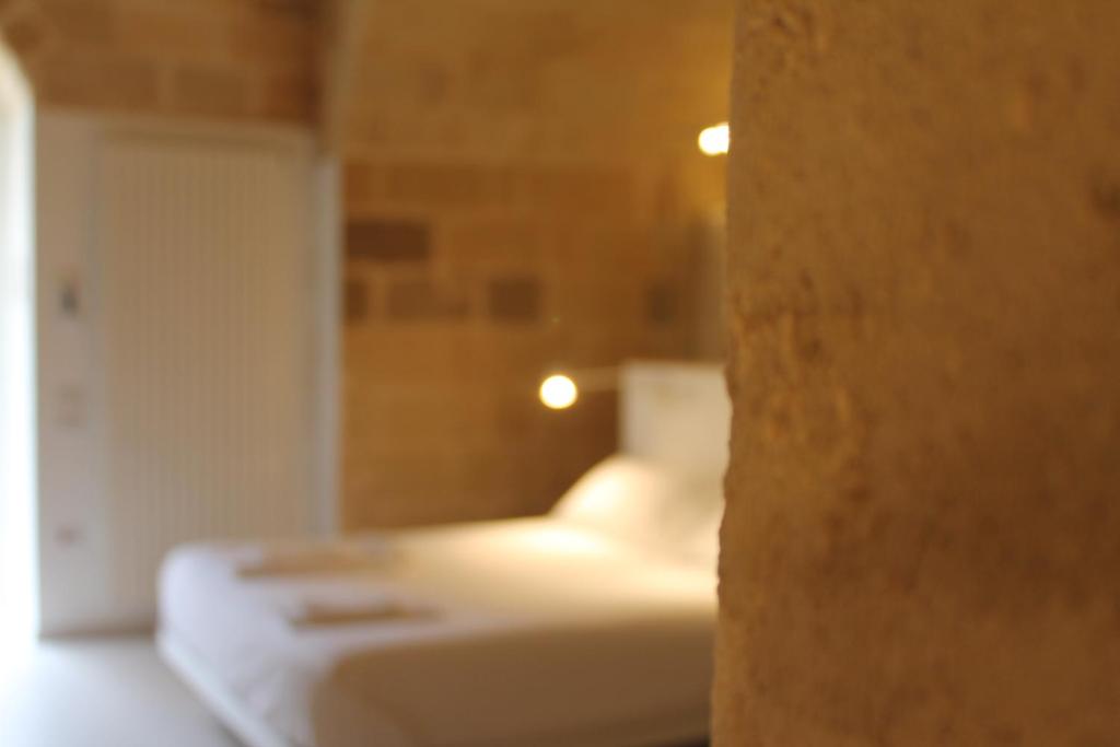 A bed or beds in a room at Endea Suite Rooms & Lounge SPA