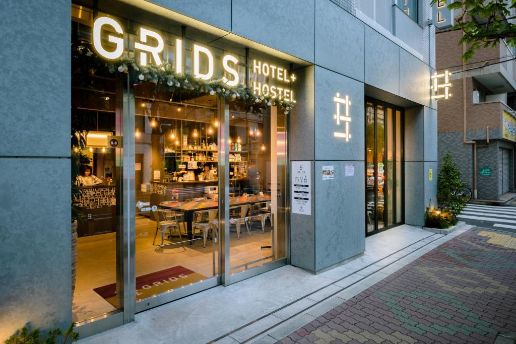 a restaurant with a sign on the front of it at Grids Tokyo Asakusa-bashi Hotel＆Hostel in Tokyo