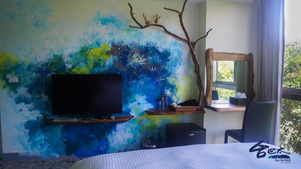 TV o dispositivi per l'intrattenimento presso Toptai Homestay