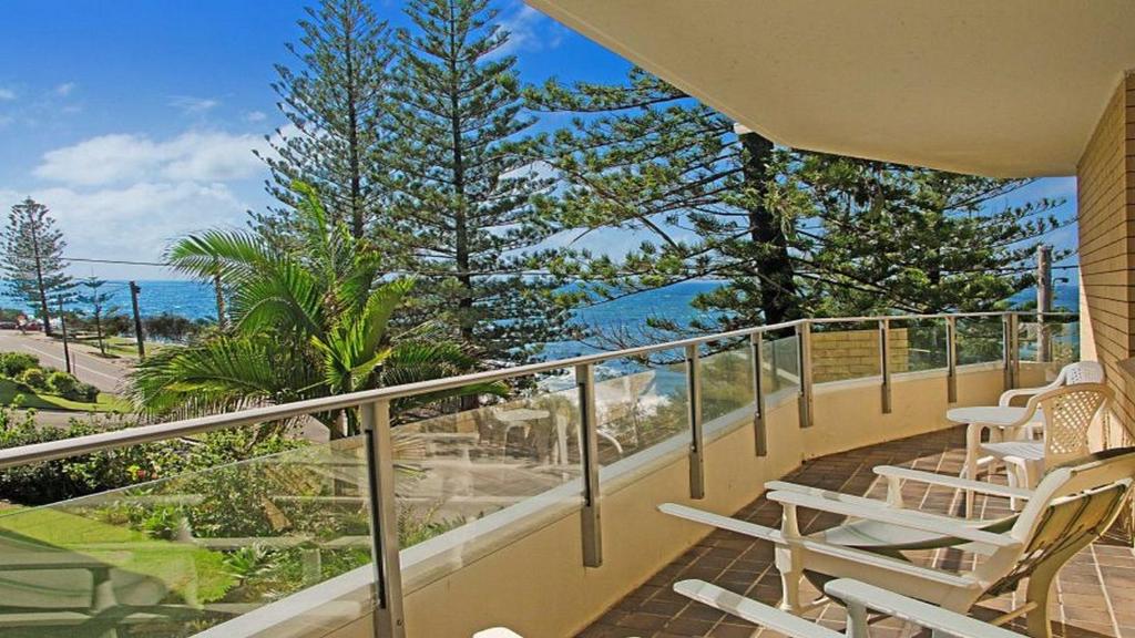 a balcony with chairs and a view of the ocean at By The Sea Unit 4, 13 Esplanade, Kings Beach in Caloundra