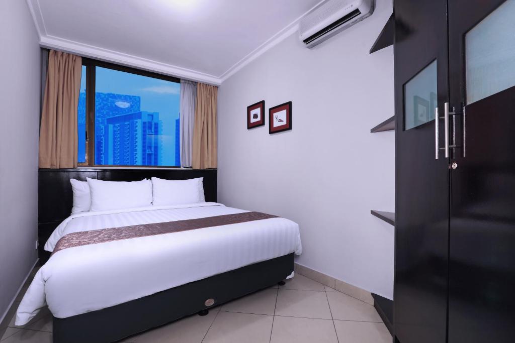 Postel nebo postele na pokoji v ubytování Horison Ultima Suite & Residences Rasuna Jakarta