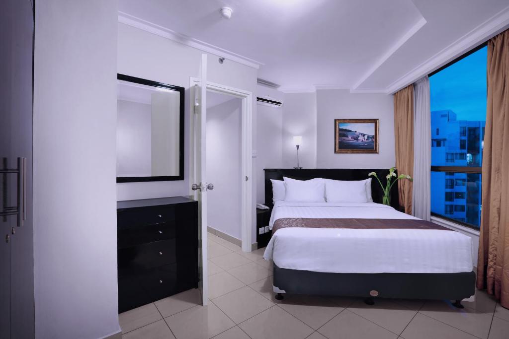 Postel nebo postele na pokoji v ubytování Horison Ultima Suite & Residences Rasuna Jakarta