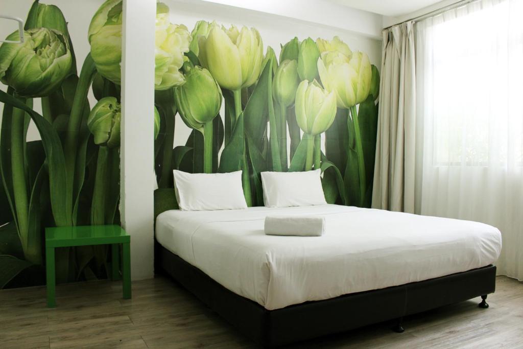 Postel nebo postele na pokoji v ubytování V Garden Hotel