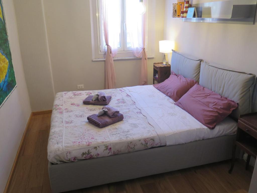 a bedroom with a bed with two slippers on it at CAVOUR citra0461 in Genoa