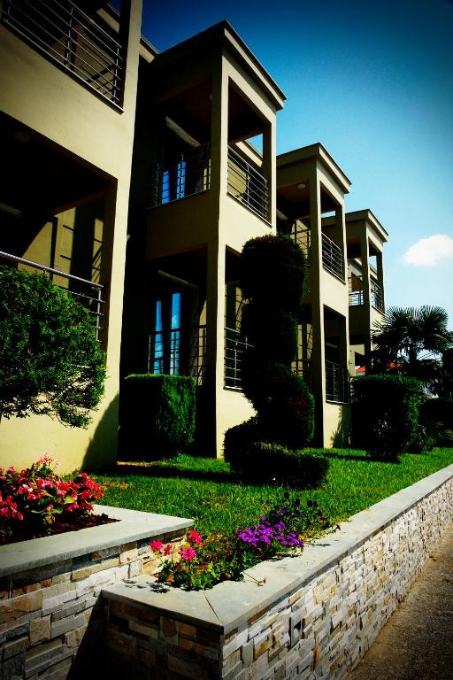 a large building with flowers in front of it at Kristonia Hotel Suites in Kilkis