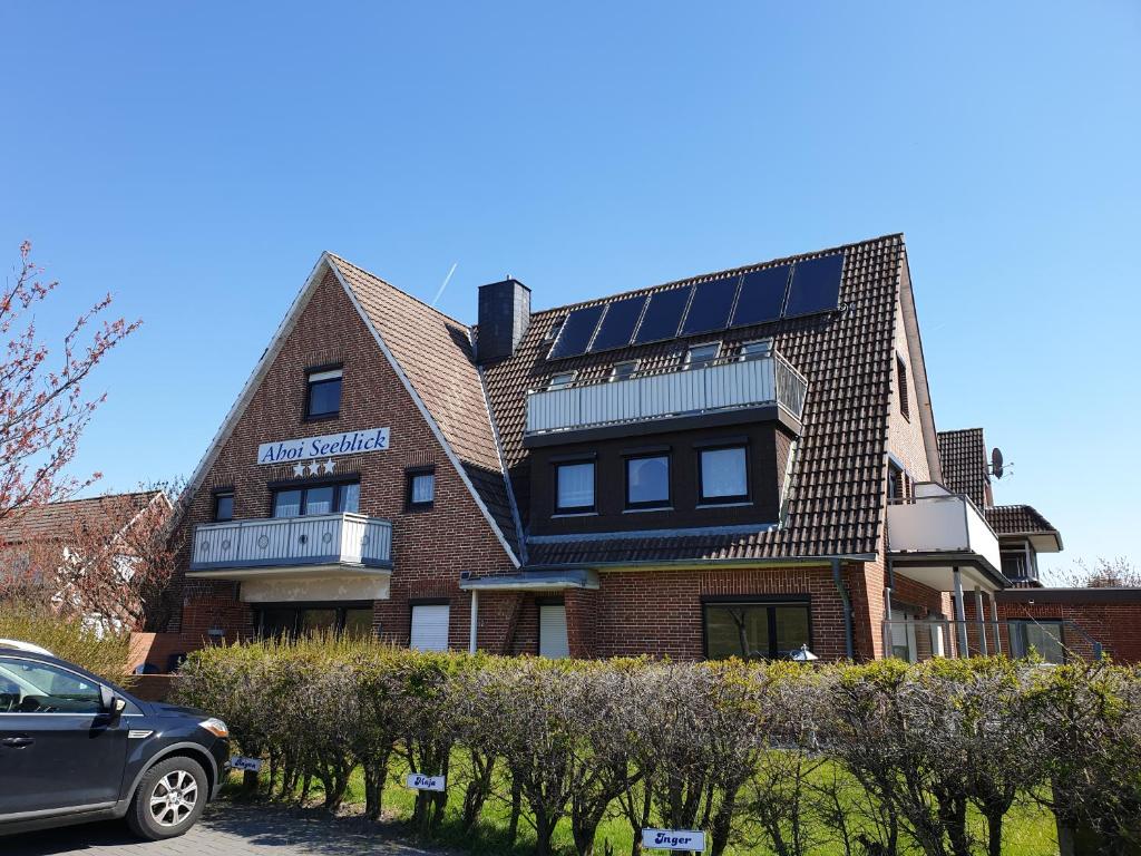 a building with solar panels on the side of it at Ahoi Seeblick in Büsum