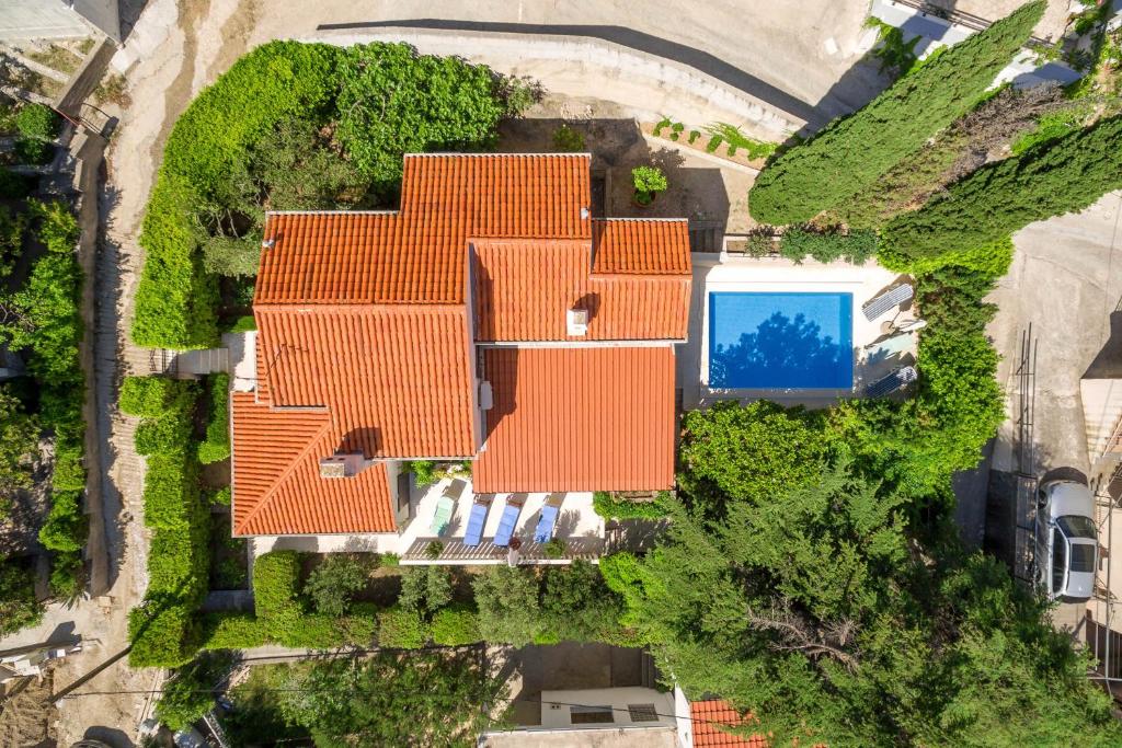 an overhead view of a house with orange roofs at Villa Skalinada - Pool, Sea View & Private Path to Beach I Baška Voda in Baška Voda