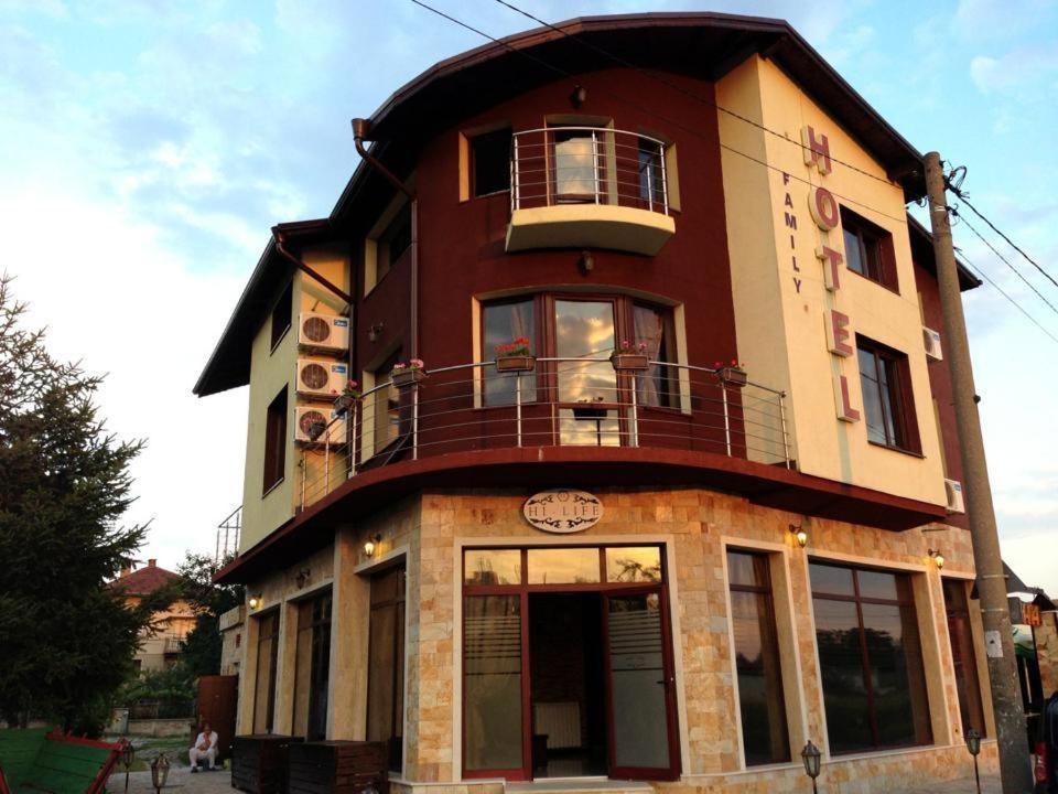 a tall building with a balcony on top of it at Hi-Life Family Hotel in Novi Iskŭr