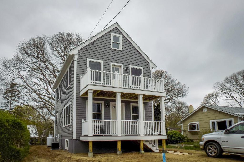 a house with a balcony on the front of it at Bella Luna in Falmouth
