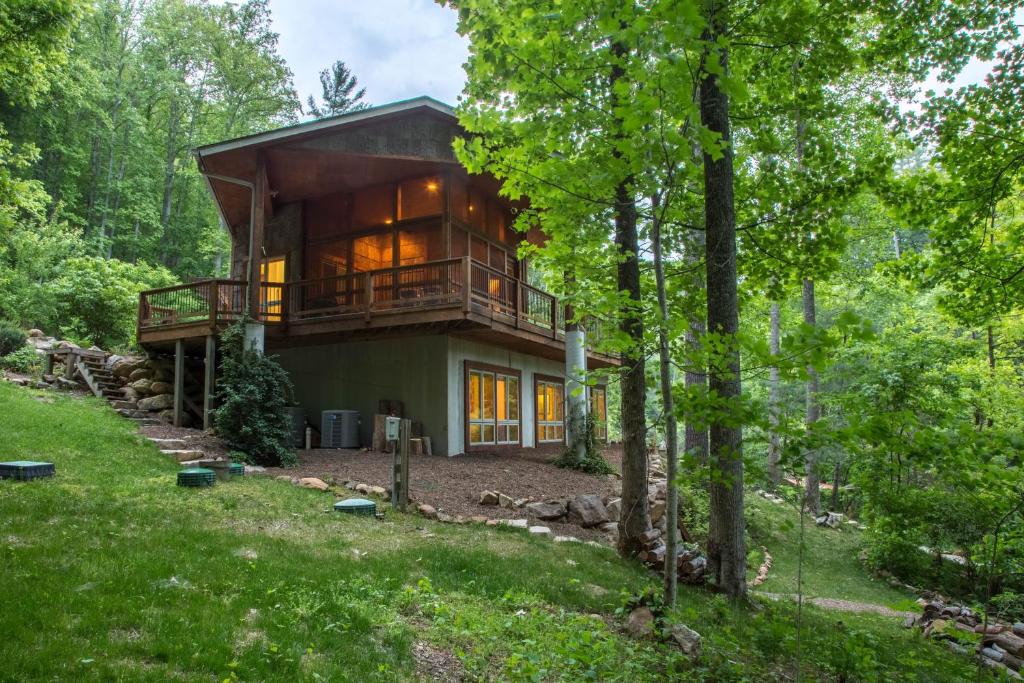 a house in the woods with a wrap around porch at 5 Bed 4 Bath Vacation home in Tuckasegee in Tuckasegee